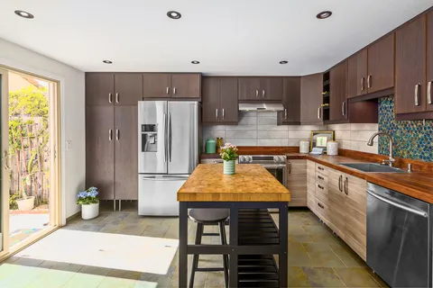a kitchen with stainless steel appliances granite countertop a sink counter space and cabinets