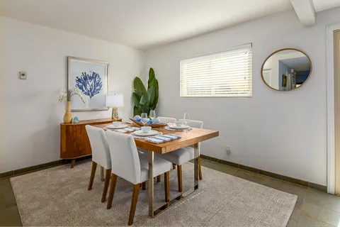 a view of a dining room with furniture and window