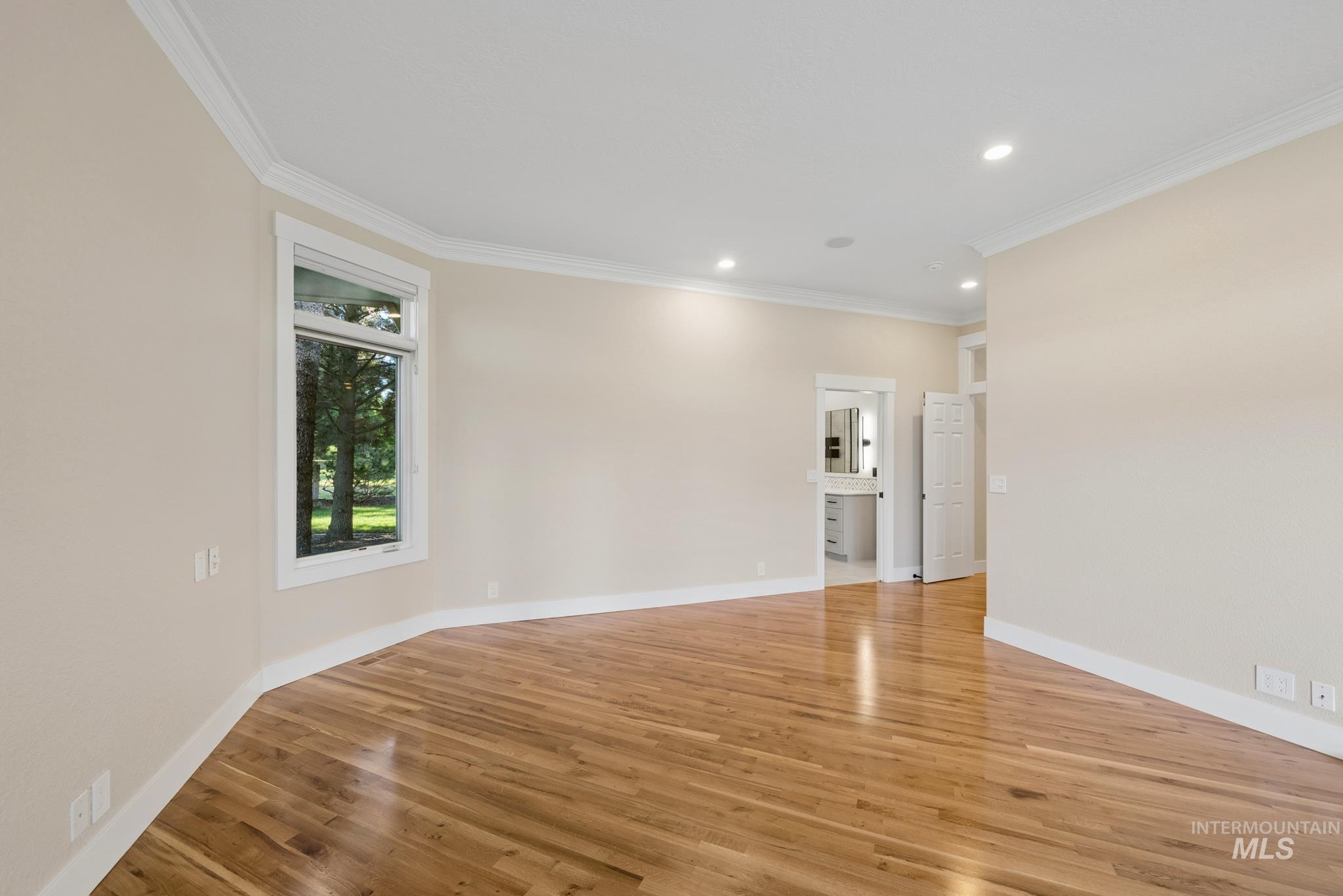 2050 Artesian Road Eagle, ID 83616 - Photo 24 of 49 Spacious room featuring wood-finish flooring, recessed lighting, and crown molding