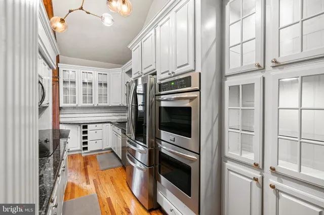 a kitchen with stainless steel appliances a refrigerator and a stove