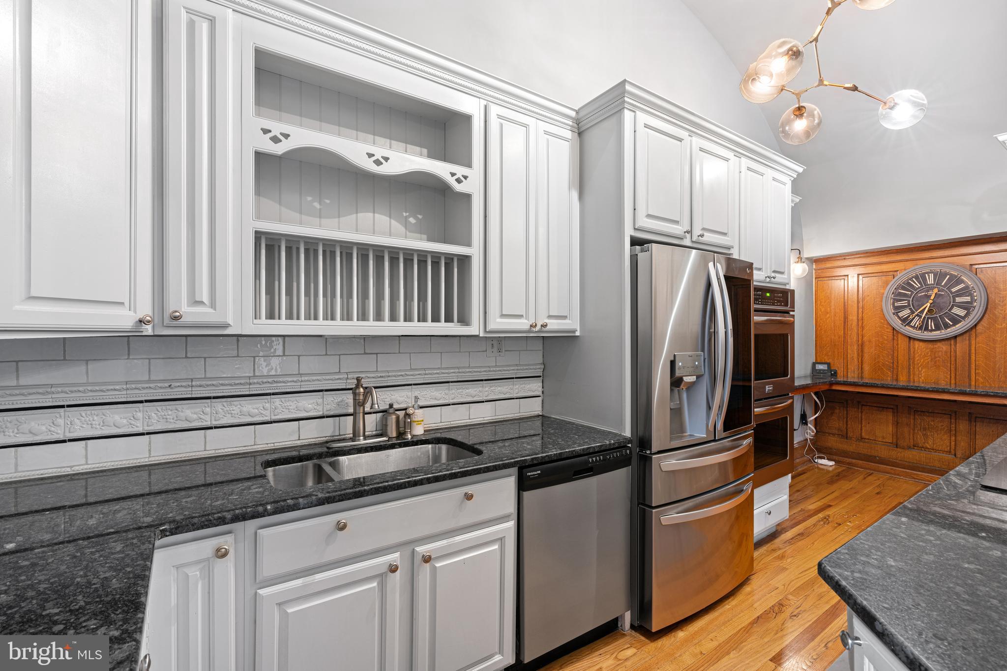 251-59 South 22nd Street, Unit A Philadelphia, PA 19103 - Photo 14 of 37 a kitchen with stainless steel appliances granite countertop a refrigerator a stove and a sink with granite countertops