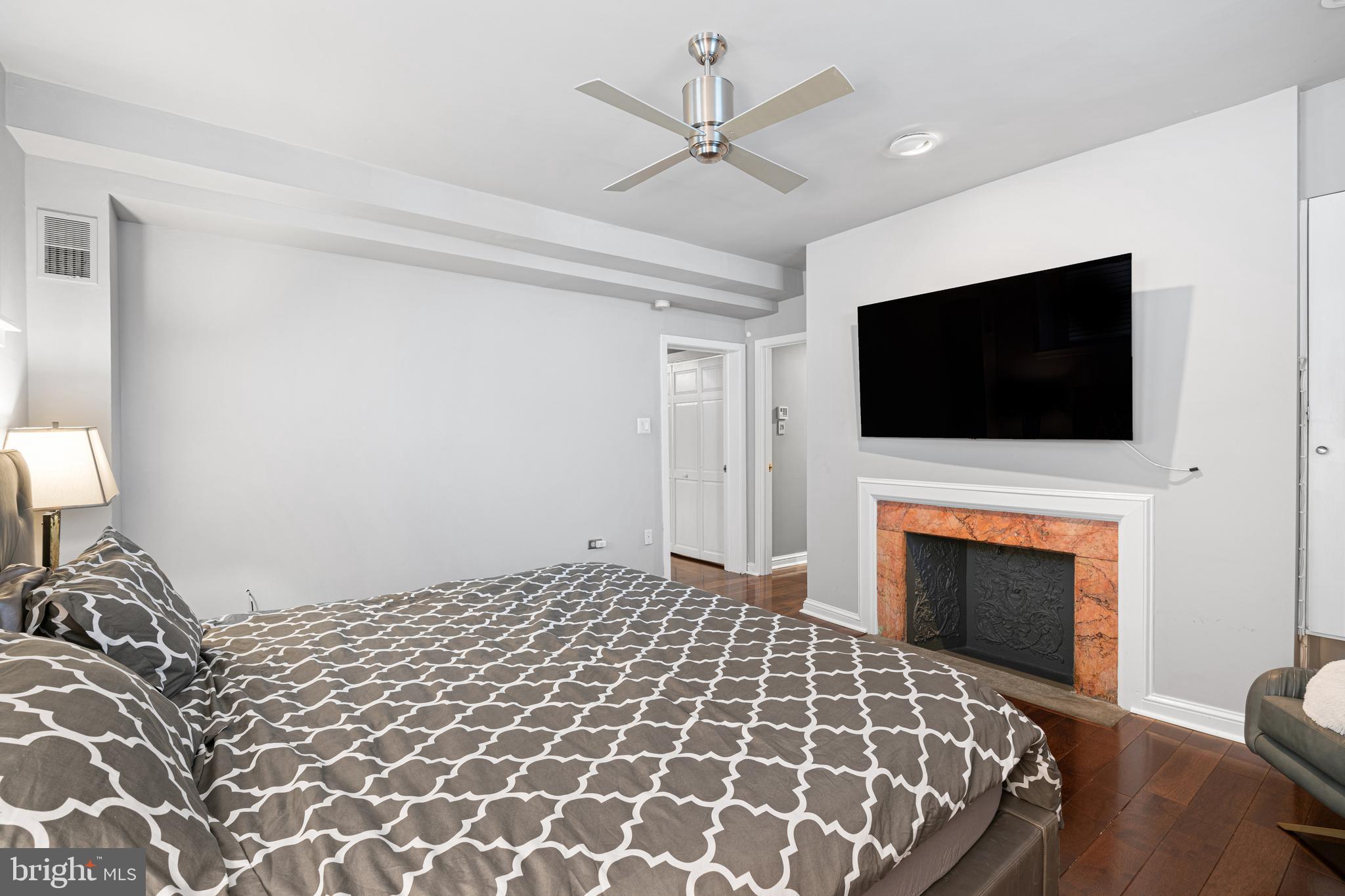 251-59 South 22nd Street, Unit A Philadelphia, PA 19103 - Photo 22 of 37 a bedroom with a bed and a flat screen tv