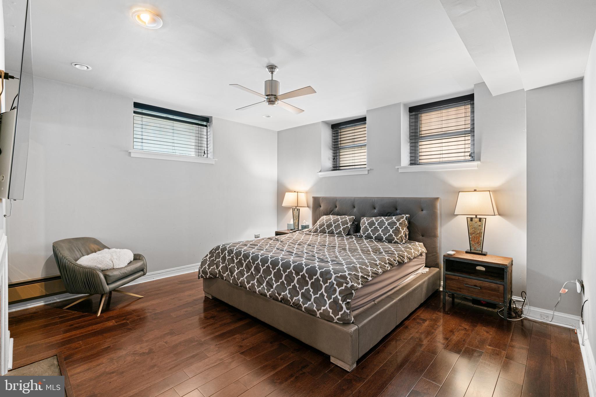 251-59 South 22nd Street, Unit A Philadelphia, PA 19103 - Photo 23 of 37 a bedroom with a bed and a chair