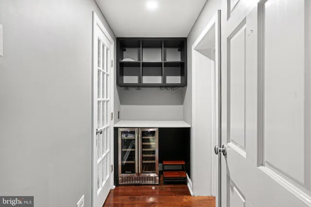 a view of a hardwood & staircase white walls