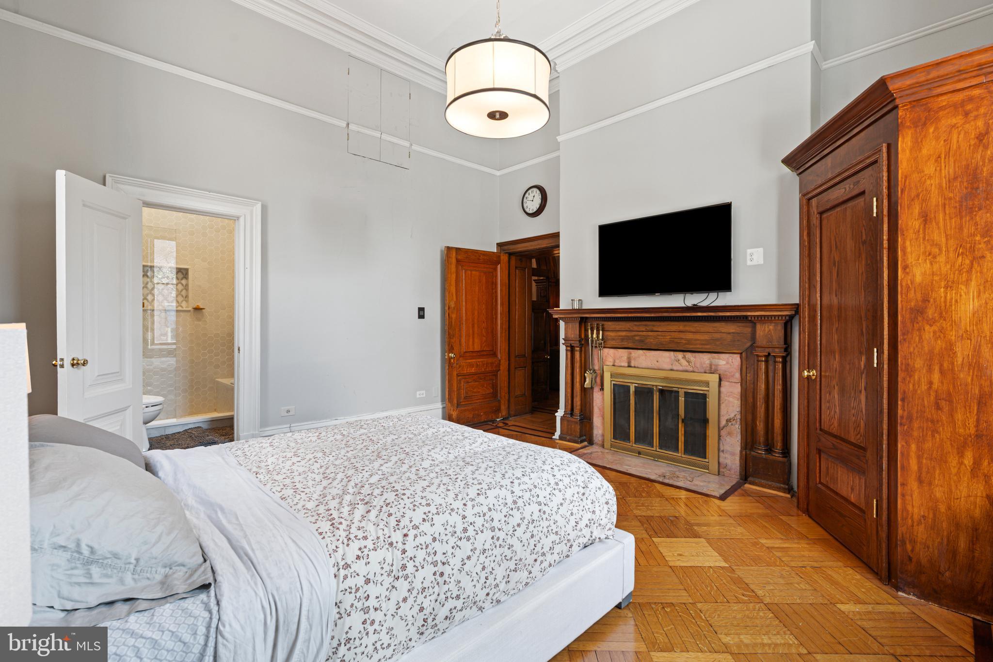 251-59 South 22nd Street, Unit A Philadelphia, PA 19103 - Photo 31 of 37 a bedroom with a bed and a flat screen tv