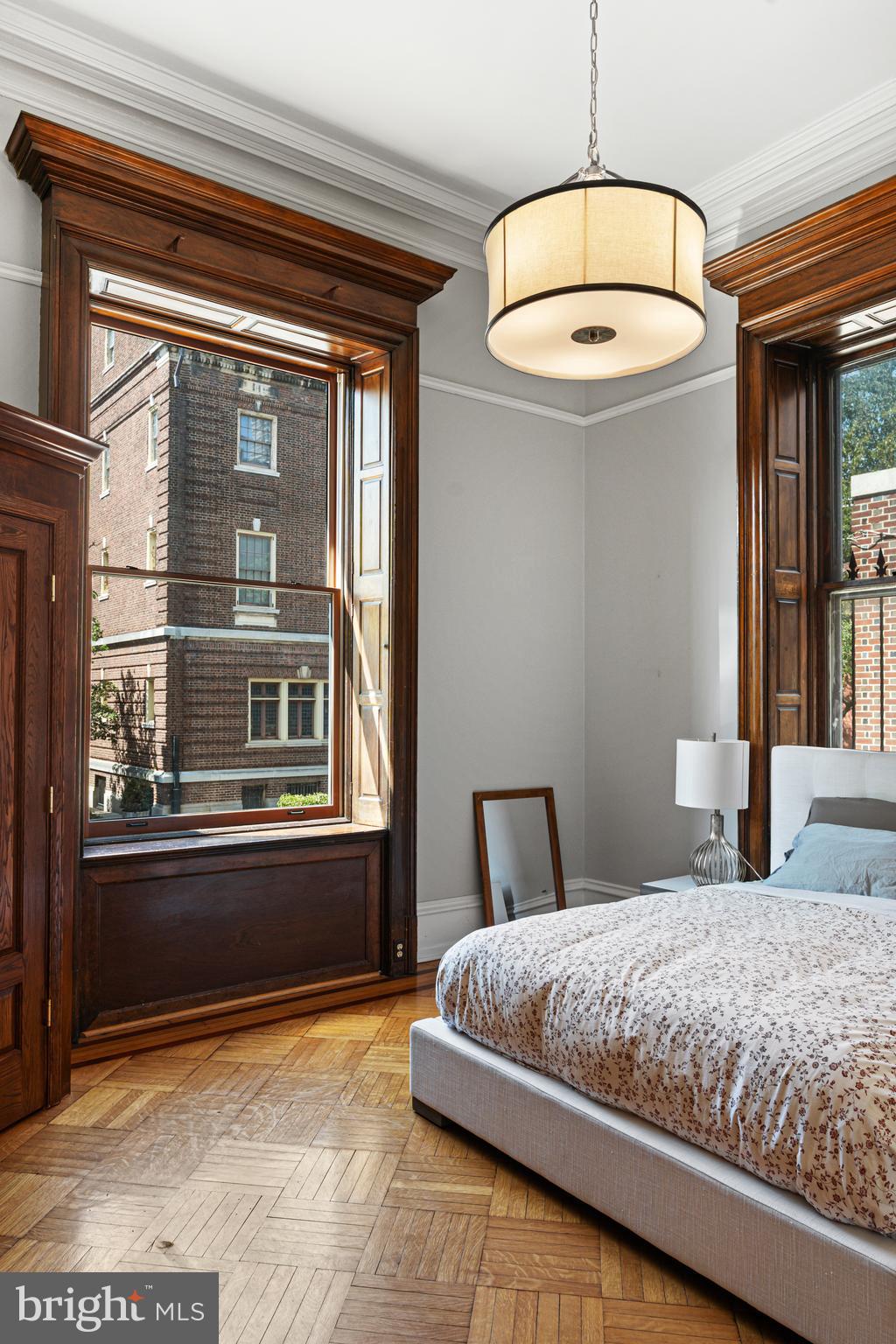 251-59 South 22nd Street, Unit A Philadelphia, PA 19103 - Photo 33 of 37 a bedroom with a large bed and a chandelier