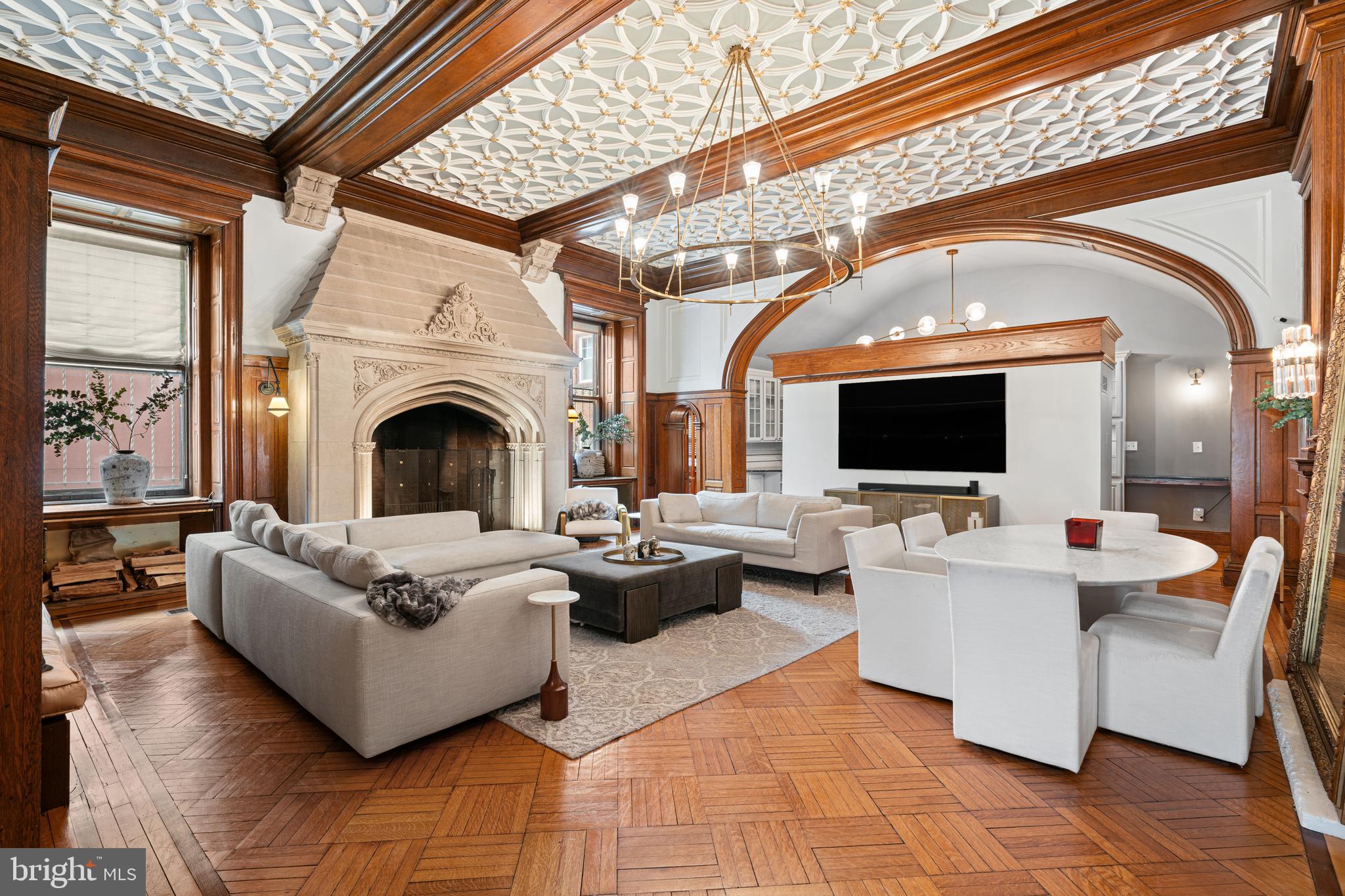 251-59 South 22nd Street, Unit A Philadelphia, PA 19103 - Photo 7 of 37 a living room with couches a flat screen tv and kitchen view