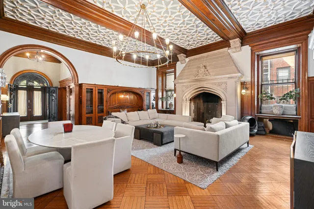 a living room with fireplace furniture and a large window