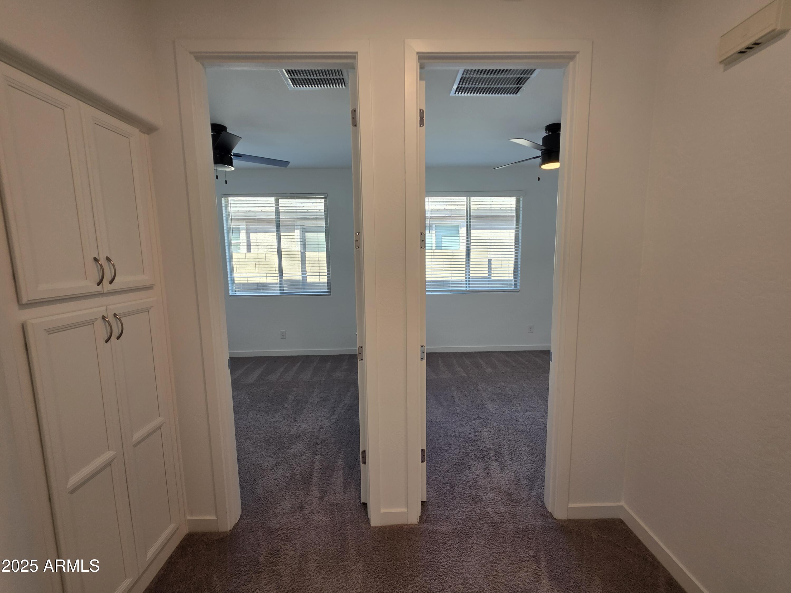 319 Pinnacle Ridge Drive San Tan Valley, AZ 85140 - Photo 13 of 25 a view of an empty room with wooden floor and a window