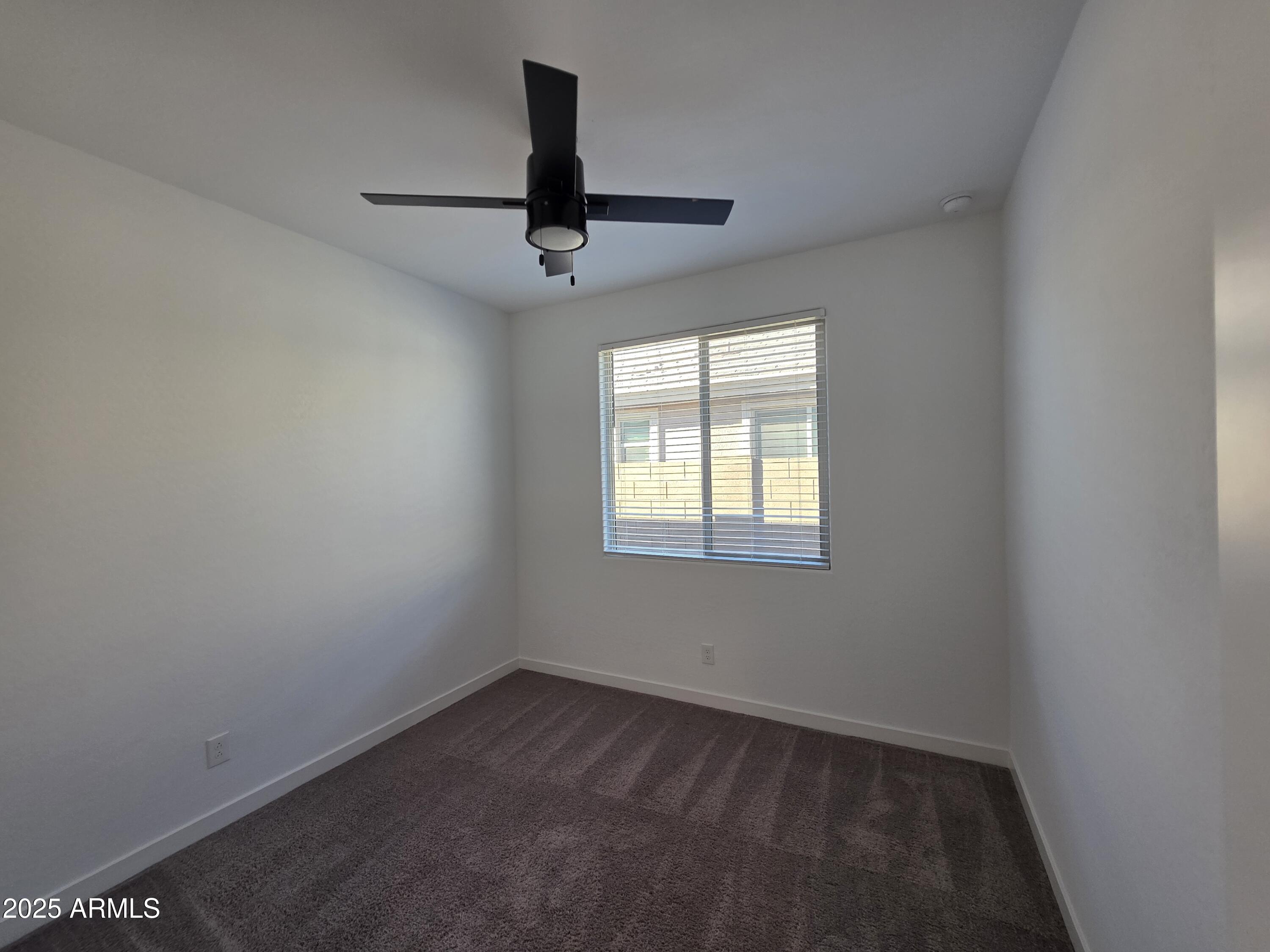 319 Pinnacle Ridge Drive San Tan Valley, AZ 85140 - Photo 16 of 25 an empty room with a window and a fan