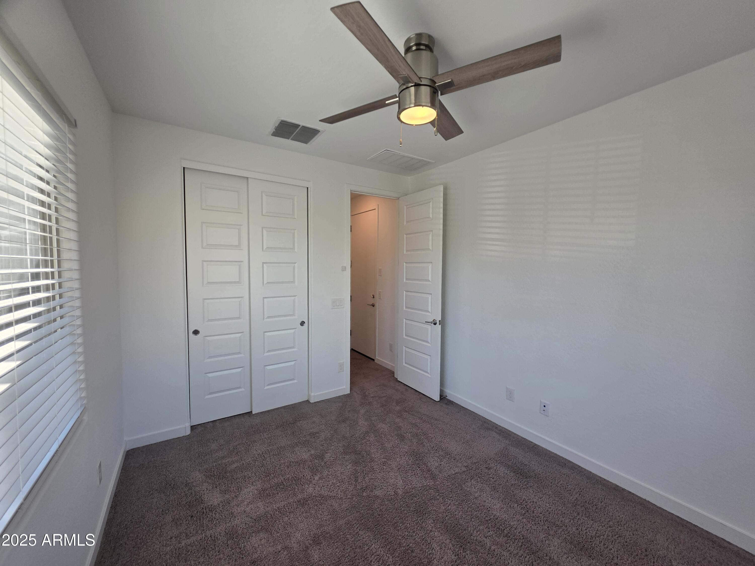 319 Pinnacle Ridge Drive San Tan Valley, AZ 85140 - Photo 19 of 25 an empty room with closet and fan