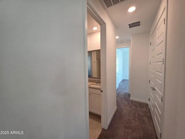 a view of hallway with wooden floor