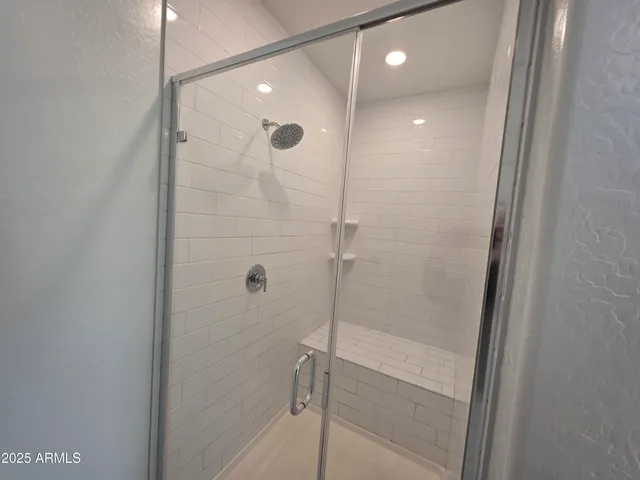 a bathroom with a shower and a sink