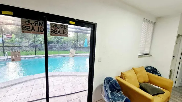 a view of a living room and floor to ceiling window