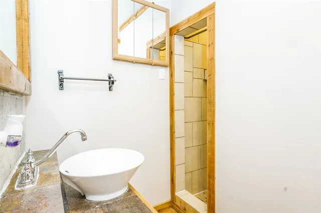 a bathroom with a toilet and a shower