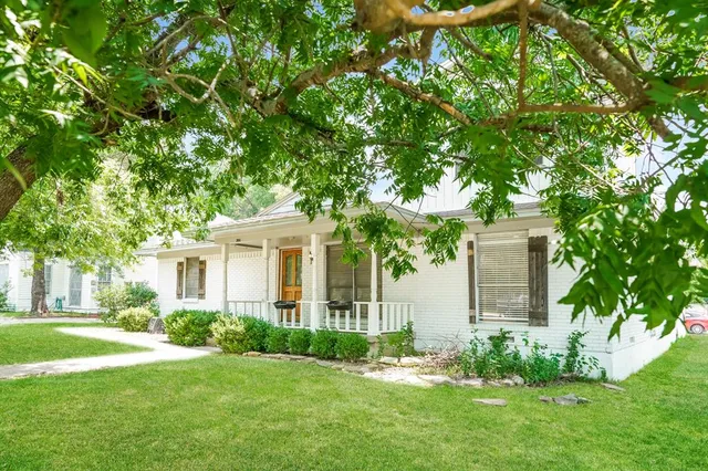 a front view of a house with a garden