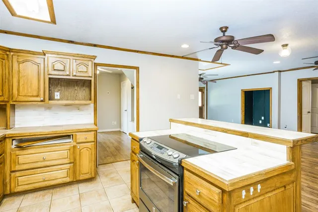 a kitchen that has a stove and a table in it