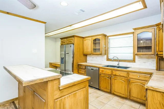 a kitchen with a sink and cabinets