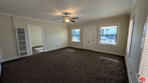 an empty room with windows and closet