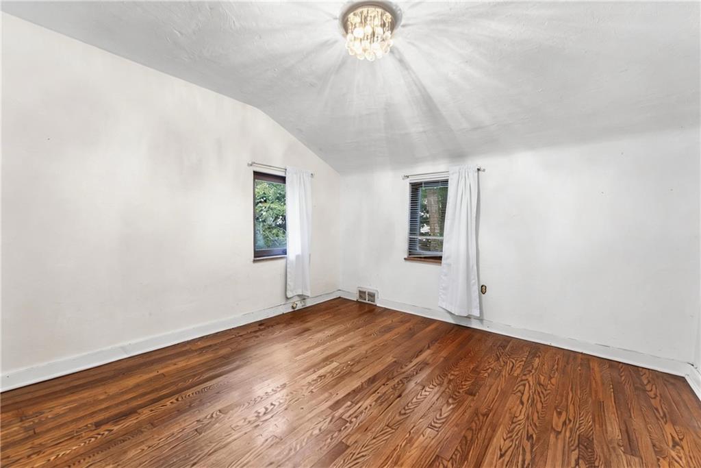 914 Bower Hill Road Pittsburgh, PA 15243 - Photo 17 of 30 an empty room with wooden floor chandelier fan and windows