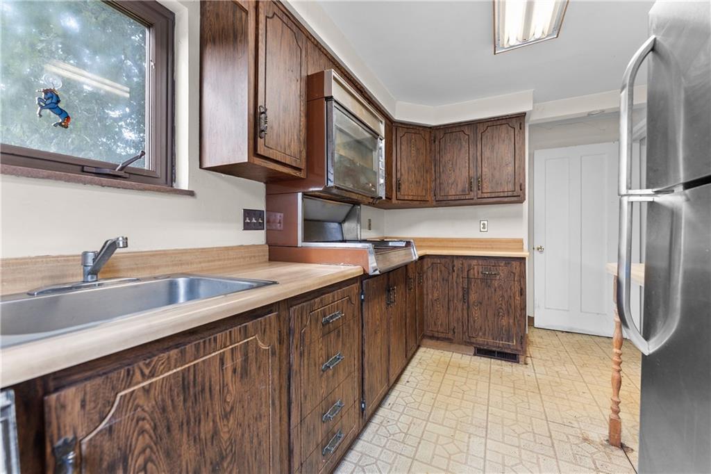 914 Bower Hill Road Pittsburgh, PA 15243 - Photo 10 of 30 a kitchen with stainless steel appliances granite countertop a sink stove and refrigerator