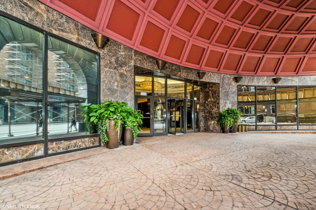 10 East Ontario Street, Unit 1109 Chicago, IL 60611 - Photo 11 of 11 a front view of a building with glass windows and garden