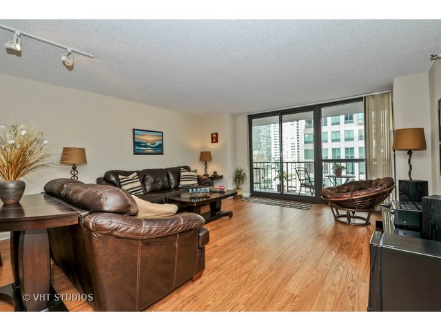 10 East Ontario Street, Unit 1109 Chicago, IL 60611 - Photo 2 of 11 a living room with furniture and a wooden floor
