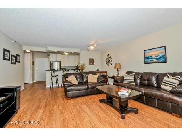 10 East Ontario Street, Unit 1109 Chicago, IL 60611 - Photo 4 of 11 a living room with furniture and a wooden floor