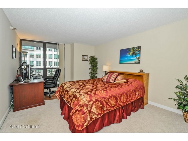 10 East Ontario Street, Unit 1109 Chicago, IL 60611 - Photo 5 of 11 a bedroom with a bed and window