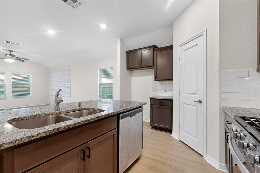 408 Rawhide Way Princeton, TX 75407 - Photo 11 of 36 a kitchen with a sink stove and refrigerator
