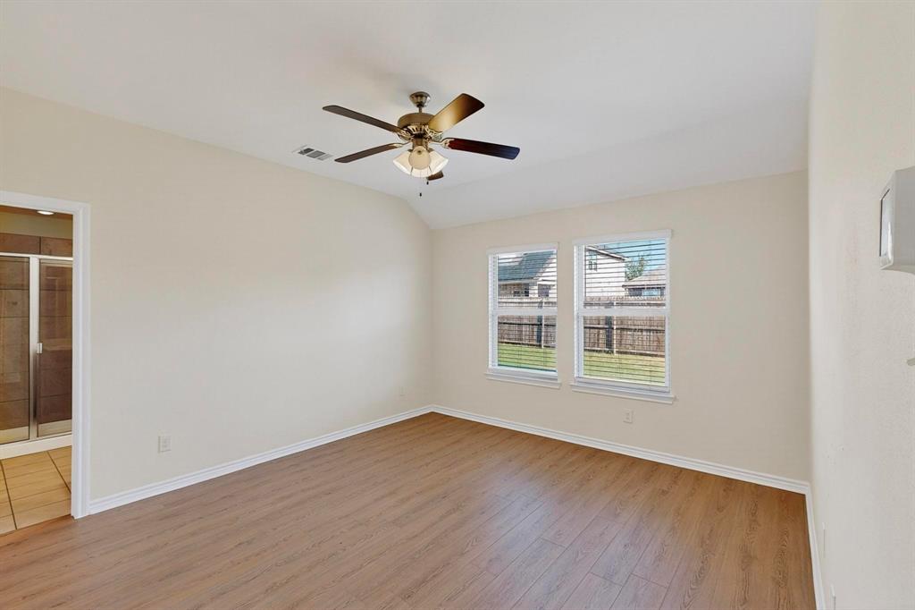 408 Rawhide Way Princeton, TX 75407 - Photo 15 of 36 a view of an empty room with a window and wooden floor