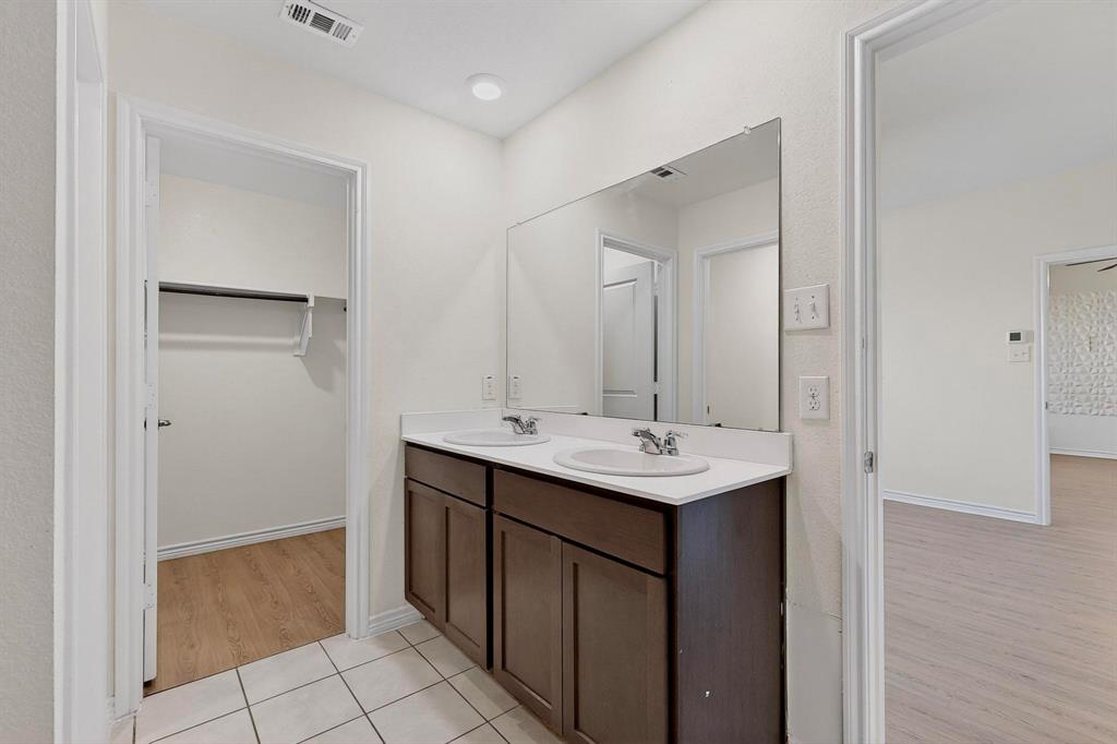 408 Rawhide Way Princeton, TX 75407 - Photo 19 of 36 a kitchen with a sink and a mirror