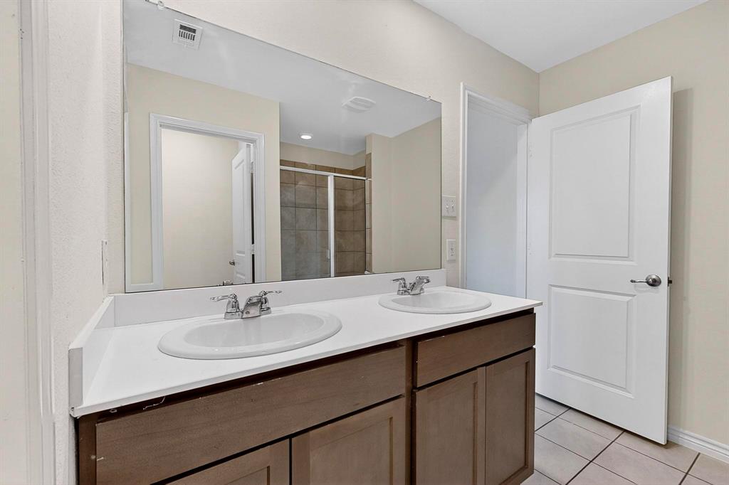 408 Rawhide Way Princeton, TX 75407 - Photo 20 of 36 a bathroom with a sink double vanity and a mirror