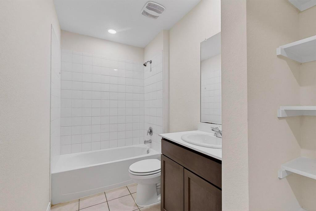 408 Rawhide Way Princeton, TX 75407 - Photo 26 of 36 a bathroom with a sink a toilet and shower