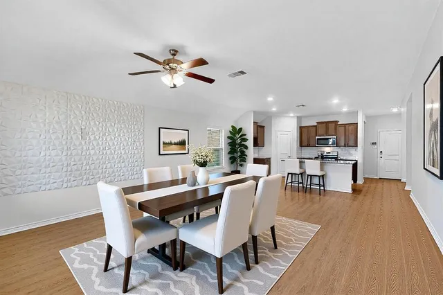a view of a living room with a ceiling fan