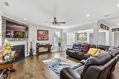 a living room with furniture a fireplace and a flat screen tv