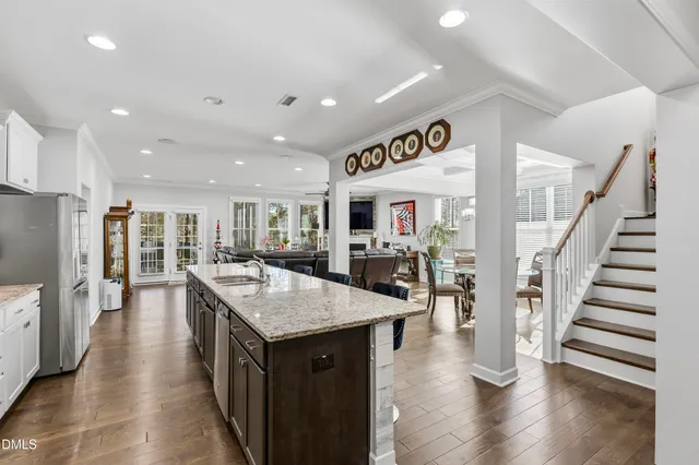 a large kitchen with lots of counter space and wooden floor