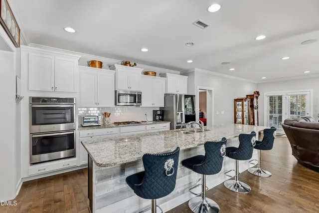 a large kitchen with a table and chairs