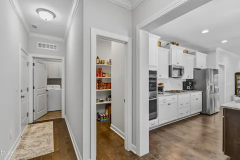 a kitchen with white cabinets and stainless steel appliances
