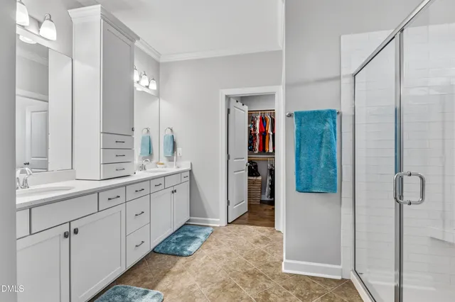 a spacious bathroom with a shower and a sink