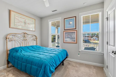 a bedroom with a bed next to a window