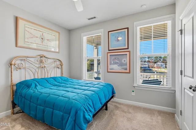 a bedroom with a bed next to a window