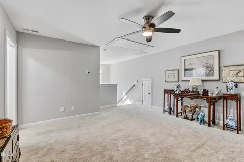 a view of a livingroom with furniture and a ceiling fan