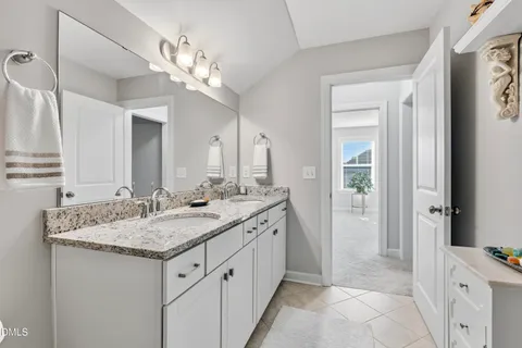a bathroom with a granite countertop sink a large mirror and a vanity