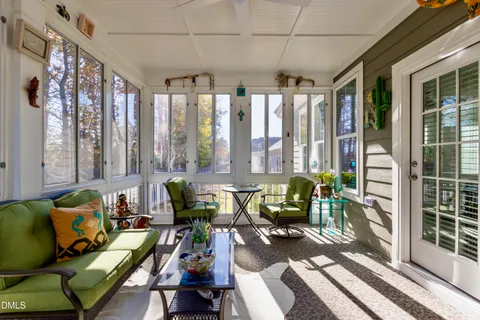 a living room with furniture and floor to ceiling windows