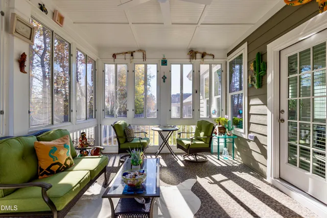a living room with furniture and floor to ceiling windows