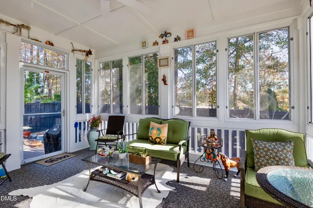 a living room with furniture and large windows