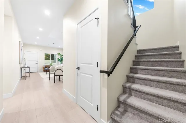 a view of a dining room with furniture and a potted plant