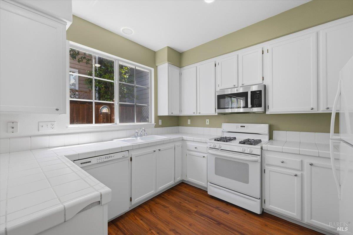 1028 Addison Circle Petaluma, CA 94952 - Photo 15 of 60 a kitchen with cabinets stainless steel appliances a sink and a window