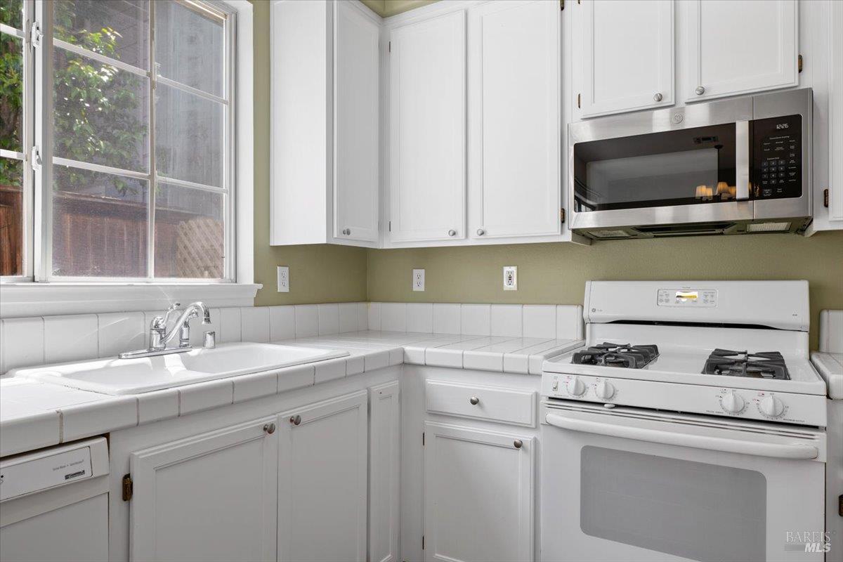1028 Addison Circle Petaluma, CA 94952 - Photo 17 of 60 a kitchen with appliances a sink and a microwave